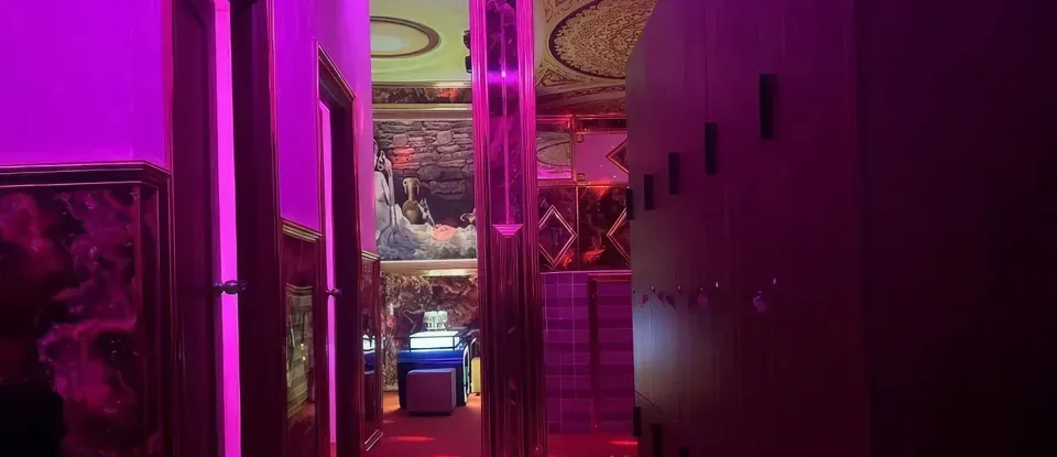 粉紅色 燈光以 打造的 按摩店 走廊